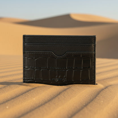 Black crocodile-patterned leather cardholder on a white background