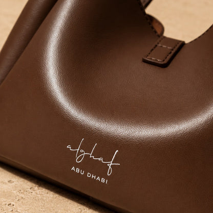 Zaya Amber amber leather handbag with Alghaf branding