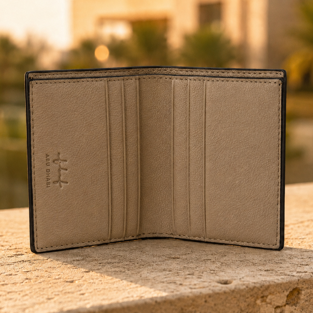 Open beige leather wallet on a stone surface with a blurred outdoor background